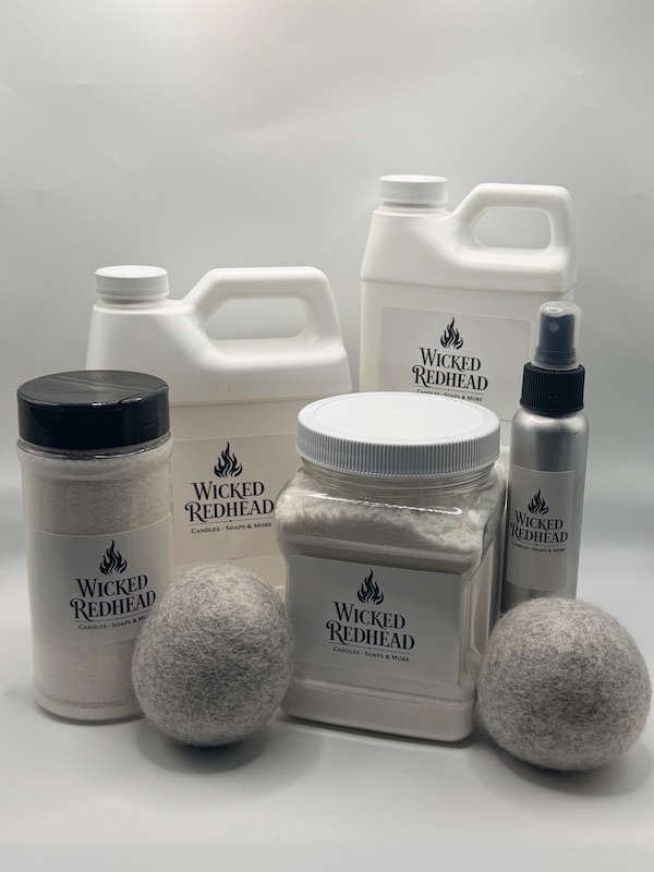 “Wicked Redhead luxury laundry collection featuring detergent jugs, laundry powder, fabric spray, and wool dryer balls on a white background.